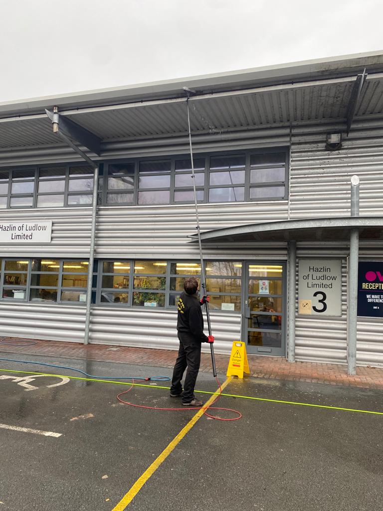 Cleaning commercial guttering from the ground with a water fed pole