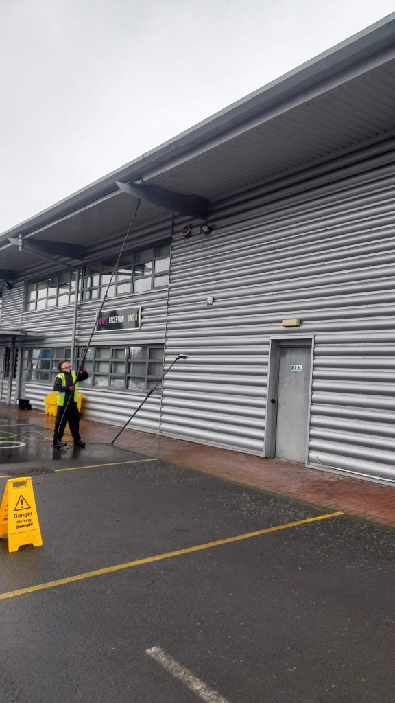 Cleaning high reach commercial soffit with a water fed pole