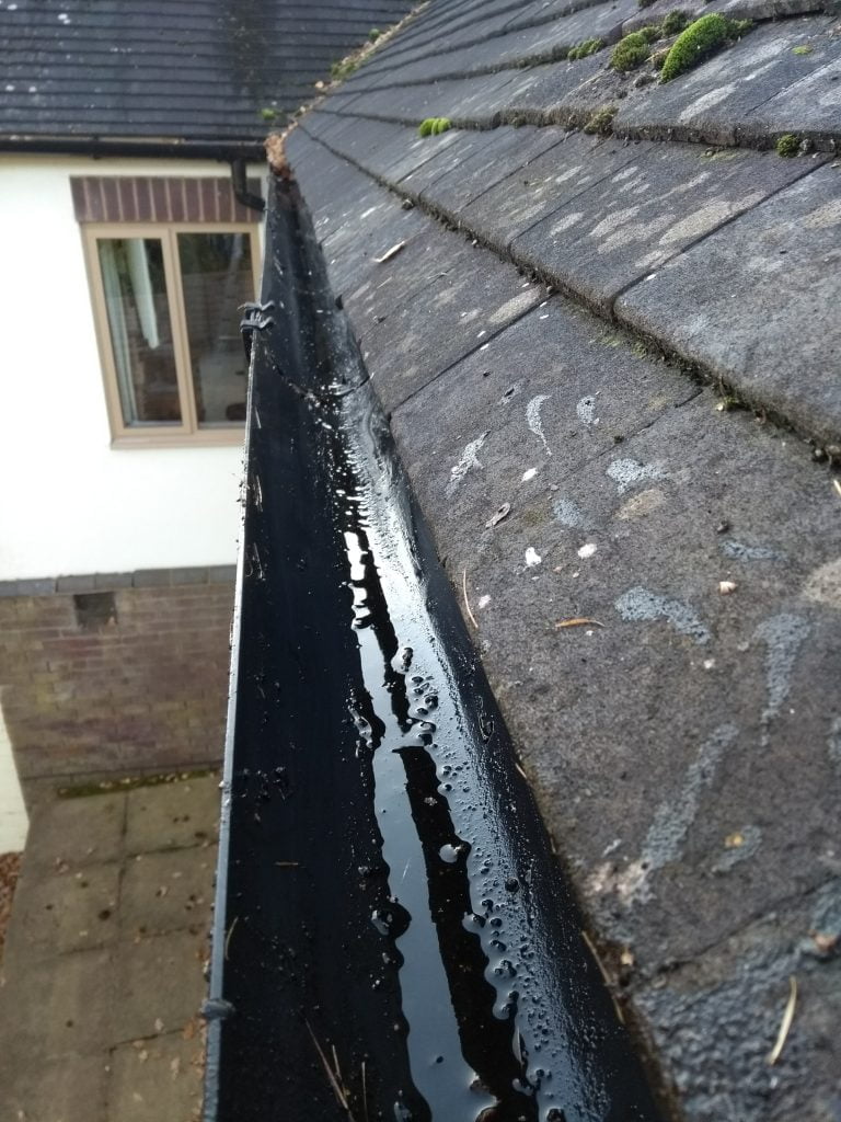 A cleared out gutter with no leaves blocking it